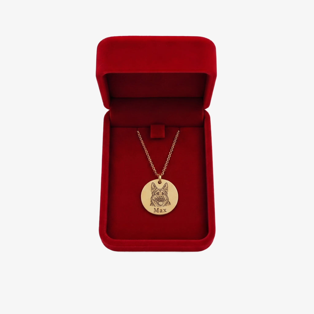 Personalized gold necklace inside the WoofCharm red gift box